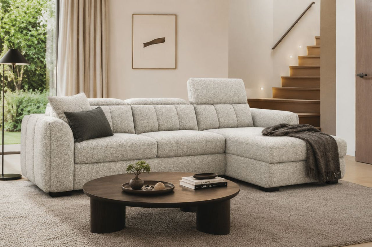 Light beige sectional sofa in a modern living room with neutral decor and natural light.