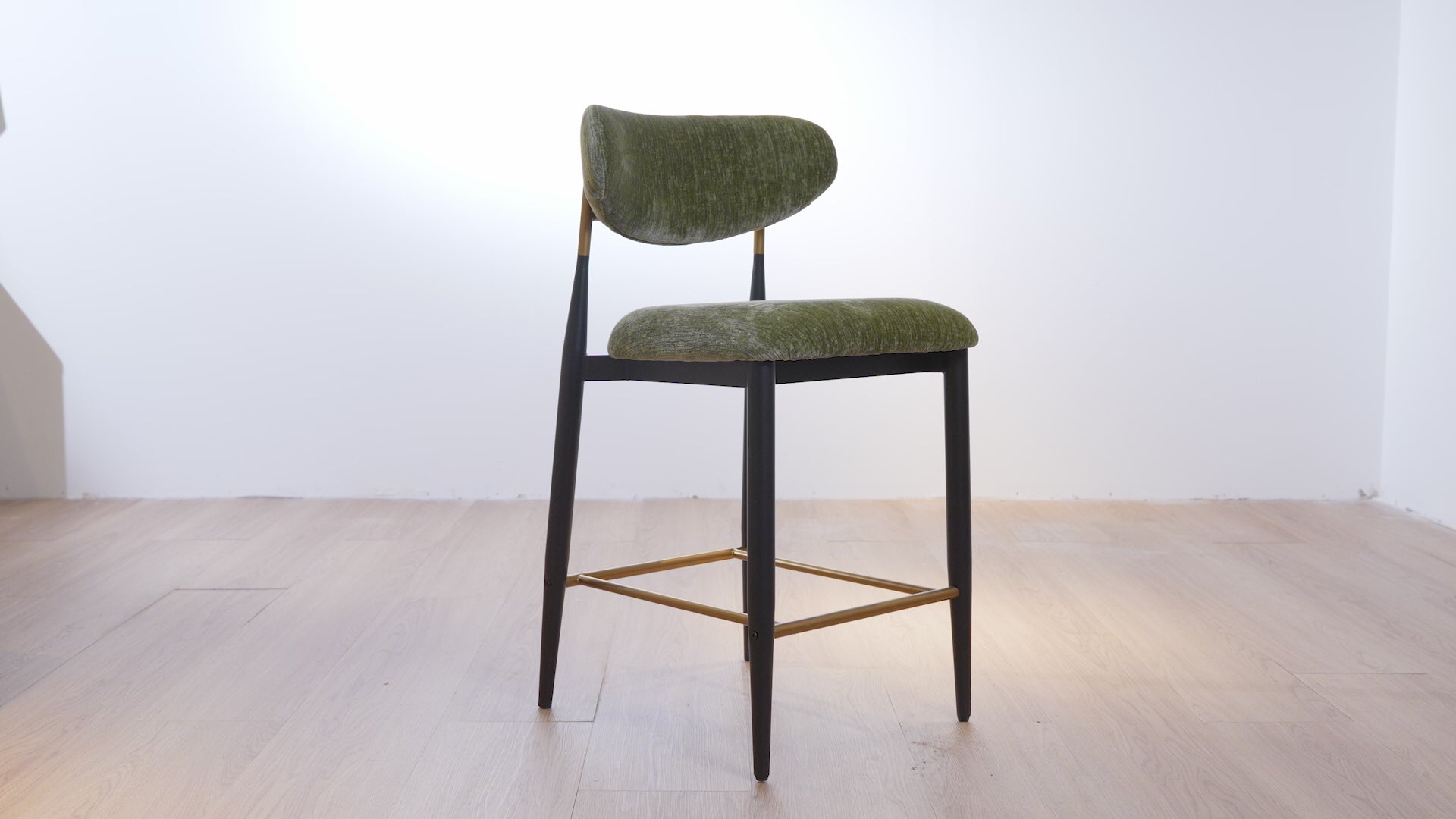 Load video: Vera Upholstered Counter Stool in Green with Matte Black &amp; Gold Legs